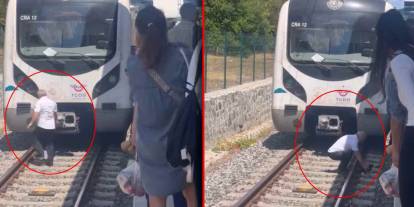 Raylardaki kediyi görünce treni durdurup yanına koştu